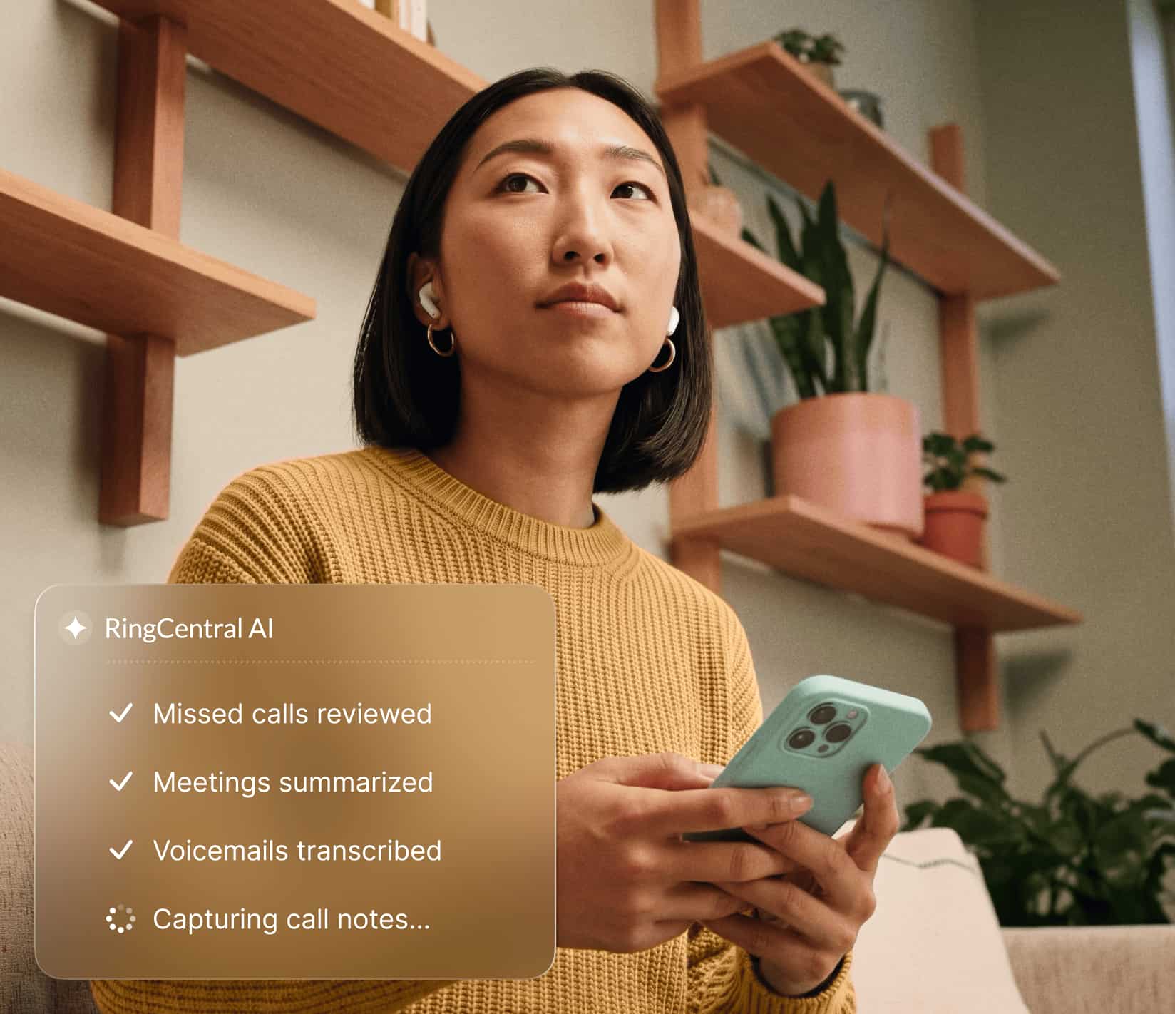 Professional using a smartphone with RingCentral AI features like call reviews, meeting summaries, and voicemail transcriptions displayed.