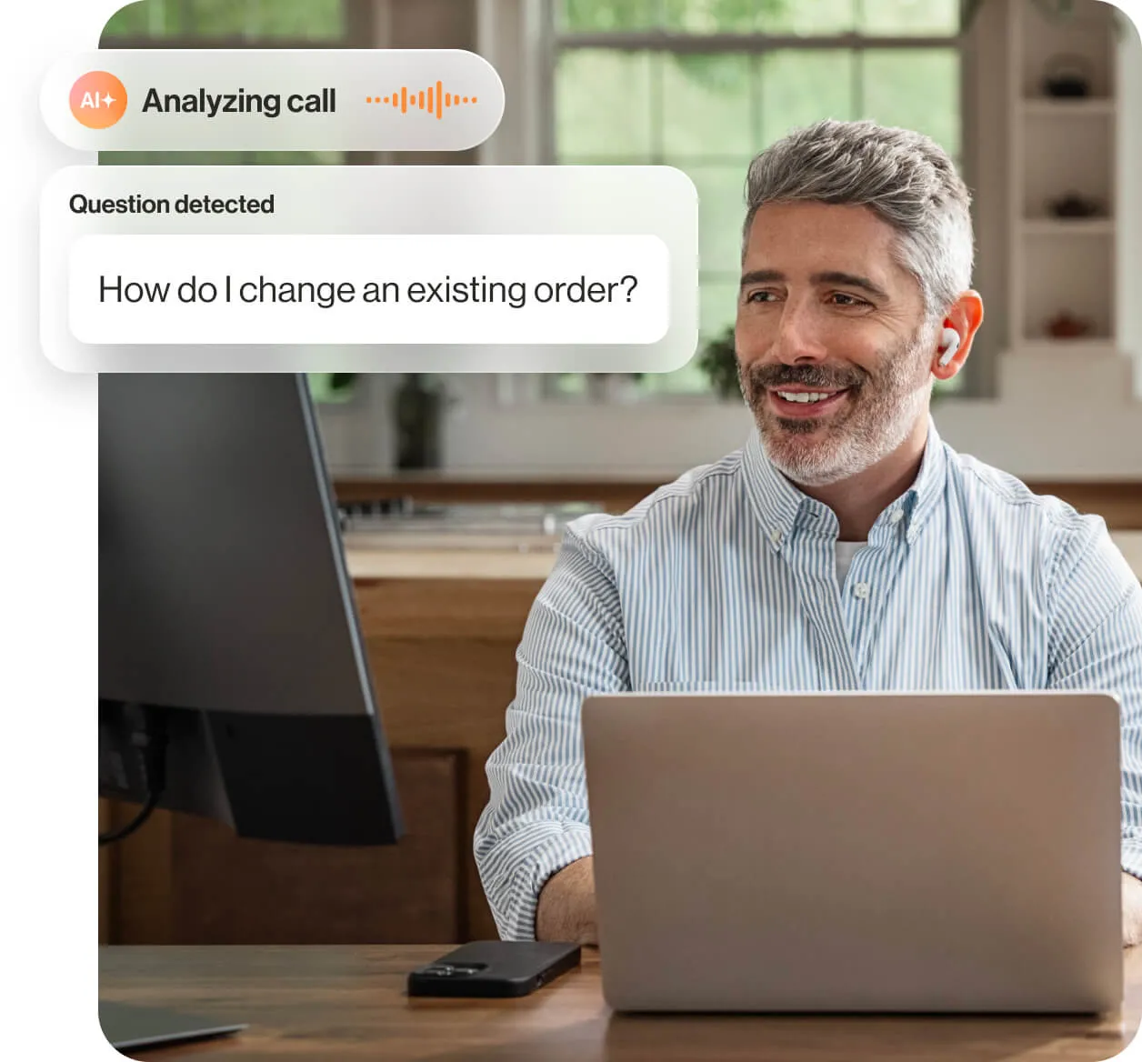 The RingCentral AI assist in use by a man working on a laptop at home