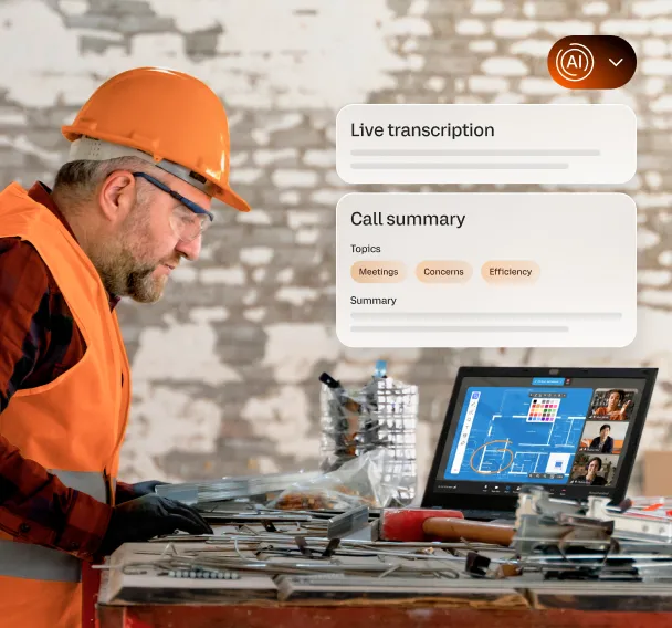 A man wearing a safety vest, and helmet attends a video conference via the RingCentral Desktop app on his laptop