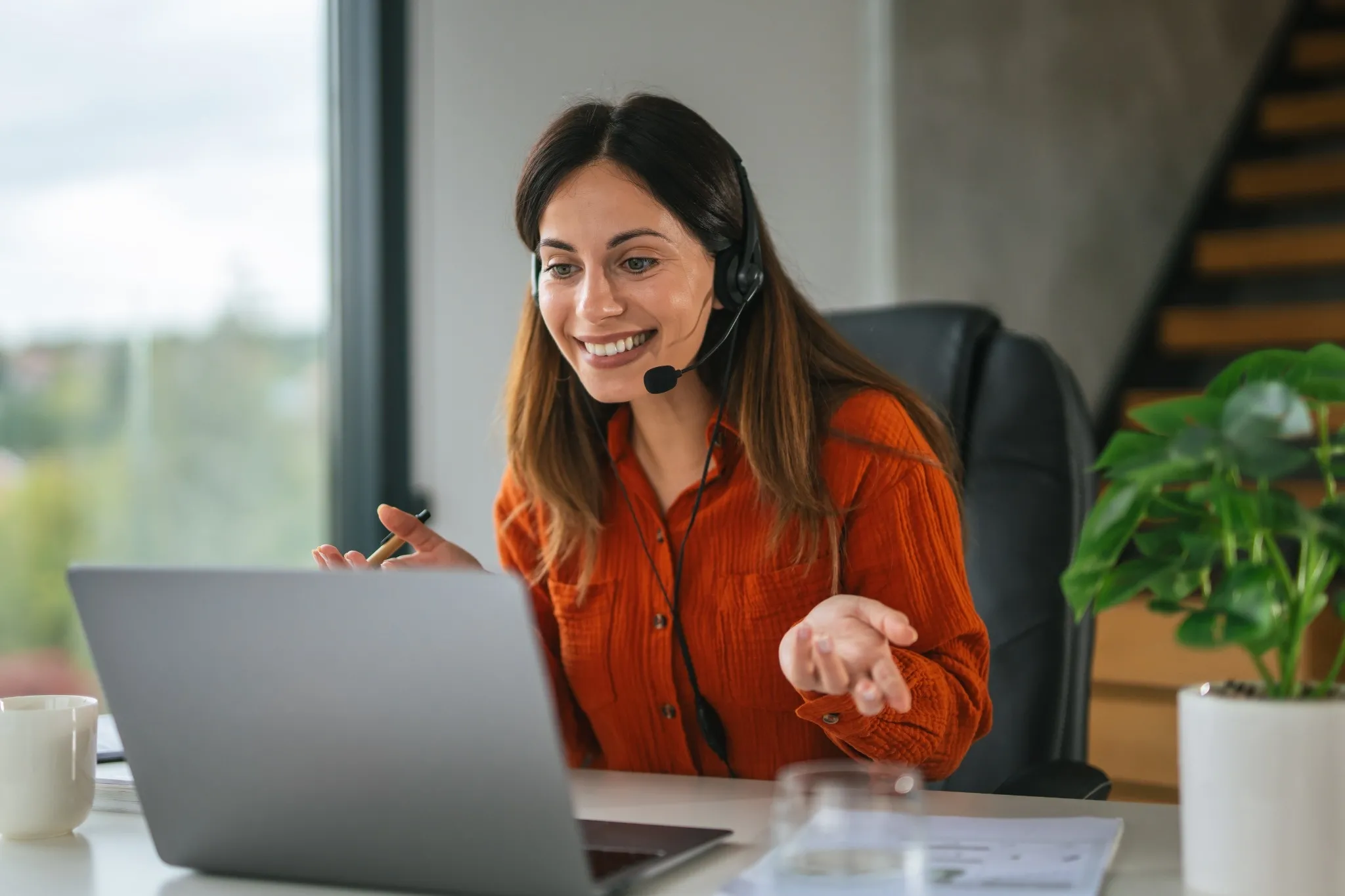 Small business owner using a VoIP phone system on a laptop.