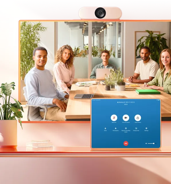 RingCentral video conferencing with diverse team at table.