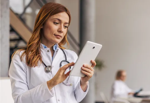 A female doctor uses RingCentral on her tablet